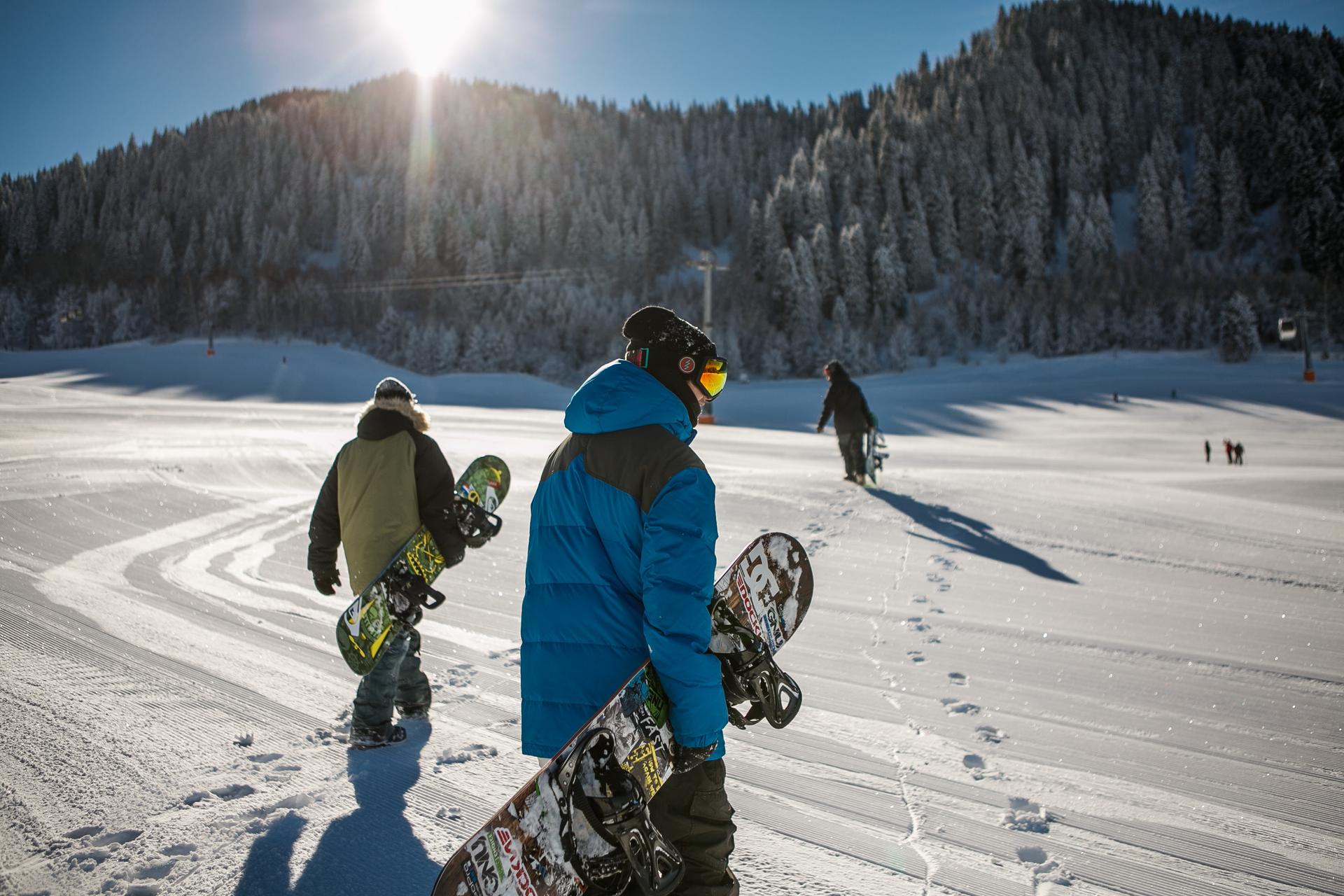 snowboarders walking to lift