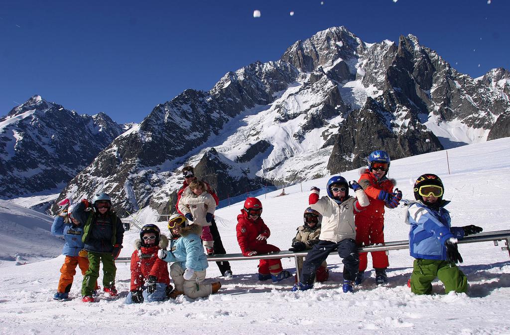 Children throwing snowballs in Courmayeur ski resort